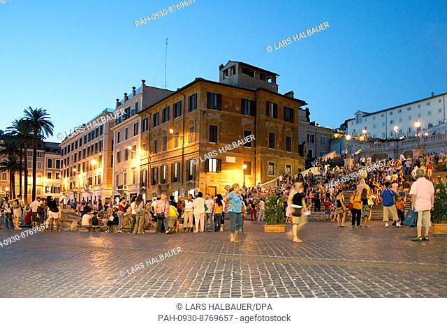 Tourists and locals crowd the place in front of the Spanish Steps during the blue hour in Rome, Italy, Wednesday, 19 July 2006
