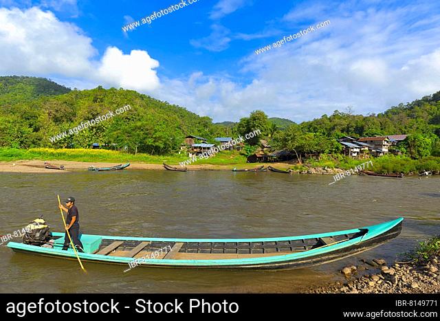 A longboat with a car engine on the Pai River, opposite the village of Huay Pu Keng where giraffe woman (longnecks) live, Mae Hong Son Province