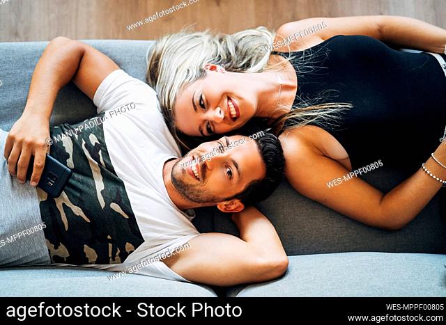 Portrait of happy couple relaxing together on the couch