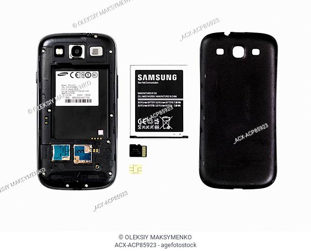 Samsung Android phone with the rear cover removed and battery, memory and SIM card taken out isolated on white background