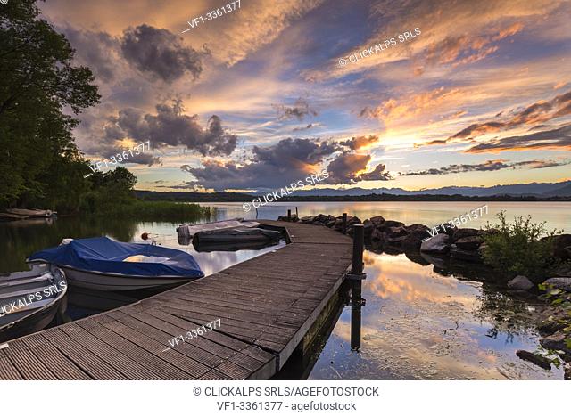 A summer sunset reflecting on Lake Varese at Cazzago Brabbia harbour, Varese Province, Lombardy, Italy