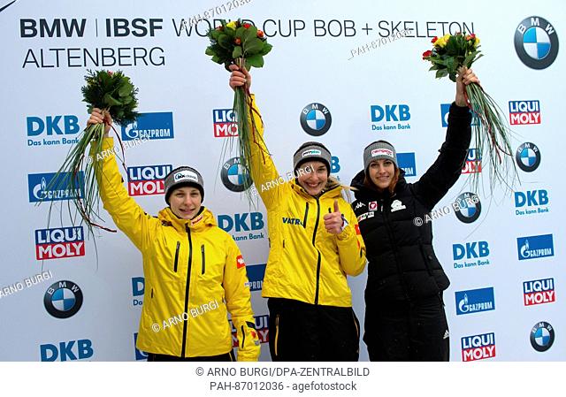 The German skeleton athlete Tina Hermann (L-R, second place), Jacqueline Loelling (first place) and the Austrian Janine Flock (third place) are visibly happy...