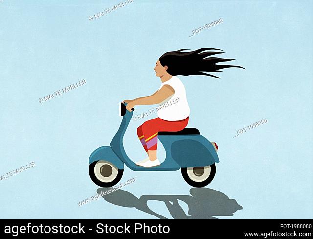 Carefree woman driving motor scooter