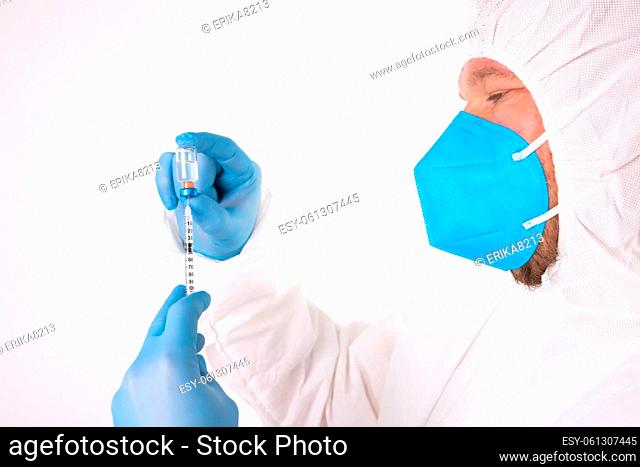 COVID-19 coronavirus vaccine. Vaccination concept. Doctor's hand in blue gloves hold medicine vaccine vial bottle and syringe