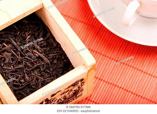 box with black tea on red mat