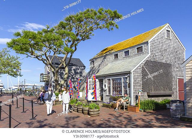 Tourists and visitors shop and stroll along Straight Wharf in Nantucket, Massachusetts