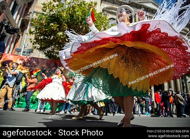 18 May 2021, Bolivia, La Paz: Women wave Bolivian flags and dance ""Morenada"" in traditional costumes. At the beginning of May 2021