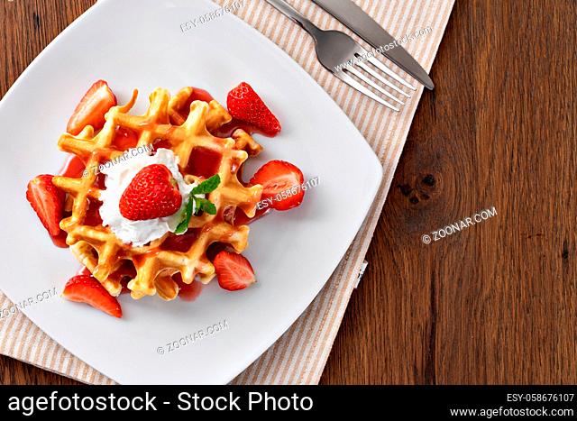 viennese waffles with strawberry and sweet syrup
