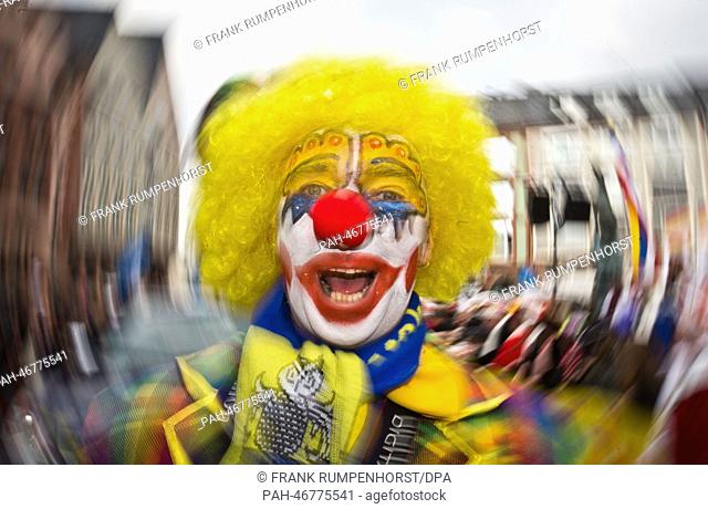 A carnival reveller is dressed as a clown during the carnival parade through Frankfurt Main, Germany, 02 March 2014. Around 400