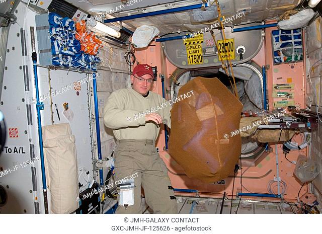 NASA astronaut Scott Kelly, Expedition 26 commander, is pictured near a stowage bag floating freely in the Unity node of the International Space Station