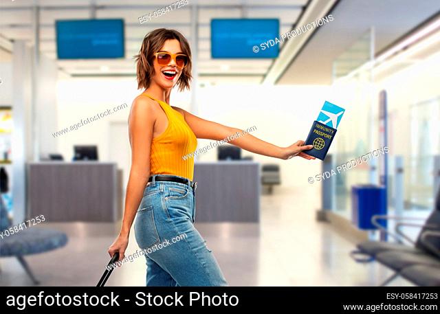 happy woman with air ticket and immunity passport