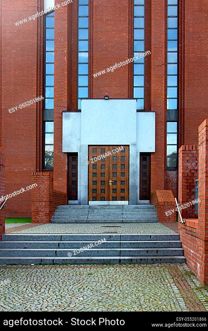 The main entrance to the building of red brick type Stalin Empire