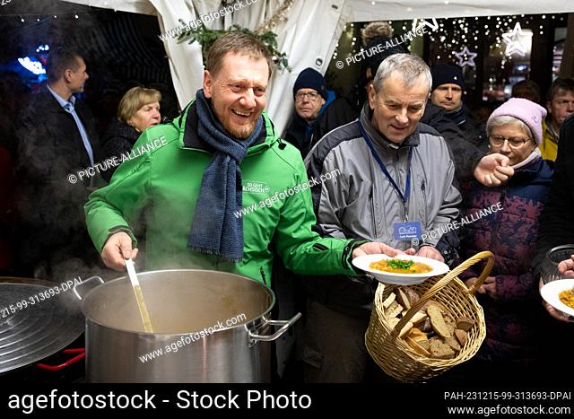 15 December 2023, Saxony, Görlitz: Michael Kretschmer (CDU, M), Minister-President of Saxony, distributes food as part of the ""17 days! 17 meals! 17 o'clock""...