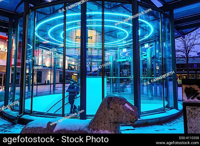 Stockholm, Sweden A man walks down a blue illuminated staircase into the Liljeholmstorget mall in the early morning