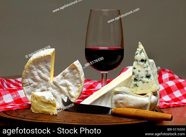 Different kinds of soft cheese and glass of red wine, Camembert, Brie, Roquefort, Pave, soft cheese
