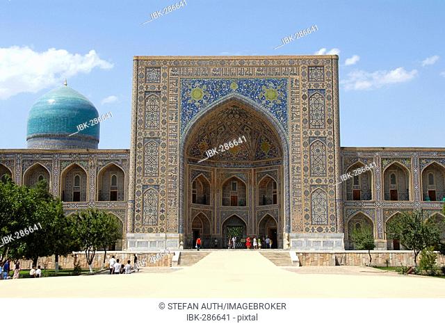 Iwan decorated with colourful tiles and blue cupola Madrasah Tilla-Kari Registan Samarkand Uzbekistan