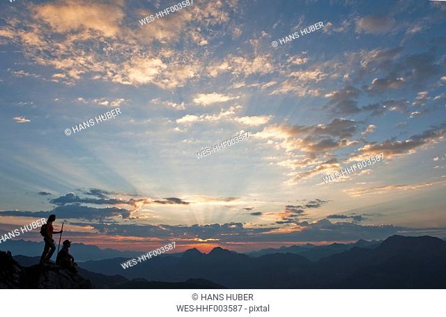 Austria, Salzburg Country, Altenmarkt-Zauchensee, Couple watching sunrise on mountains of Niedere Tauern