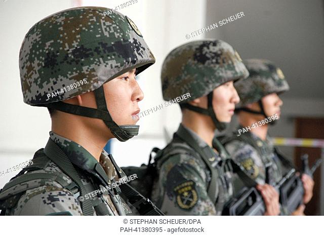 Chinese soldiers present their combat gear at a barracks near Xi'an, China, 29 July 2013. China has been investimg billions into modernising its armed forces