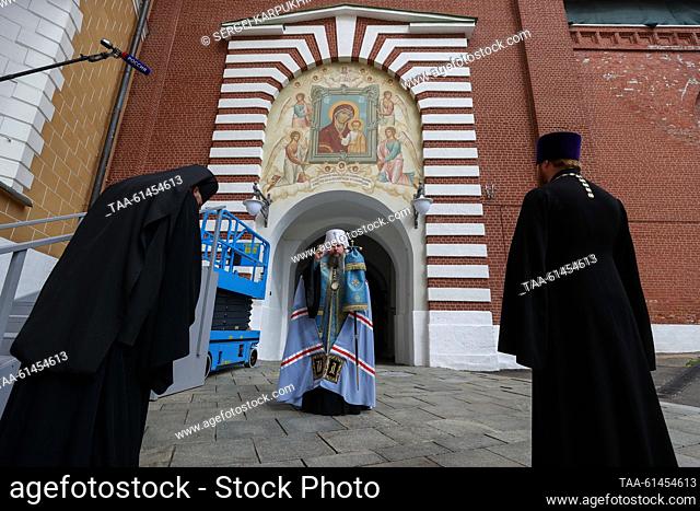RUSSIA, MOSCOW - AUGUST 28, 2023: Metropolitan Dionisy (C) of Voskresensk blesses a restored fresco of the Icon of Our Lady of Kazan on the western facade of...