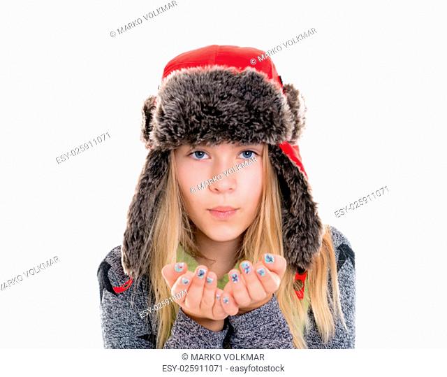 nice blond girl with fur cap and scarf blowing in to the camera