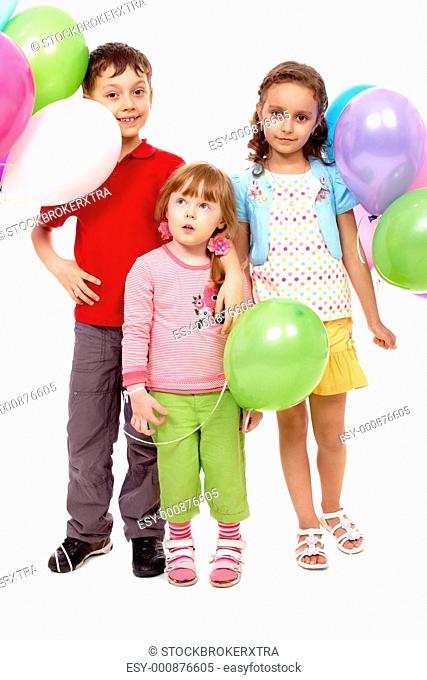 Portrait of kids with colorful balloons at birthday party
