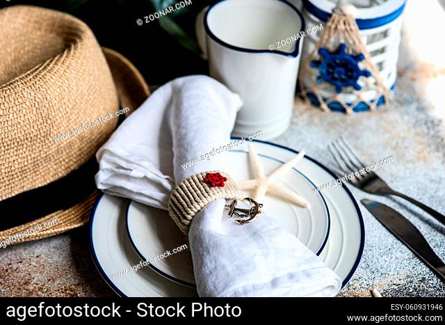 Marine table setting on concrete table as a summer background concept