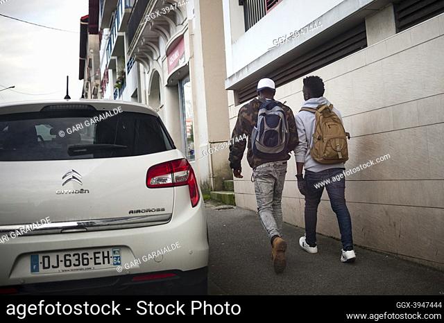 Two young African migrants who crossed the Spanish french border walking along Santiago bridge walk through the streets of Hendaye. Hendaye (France)