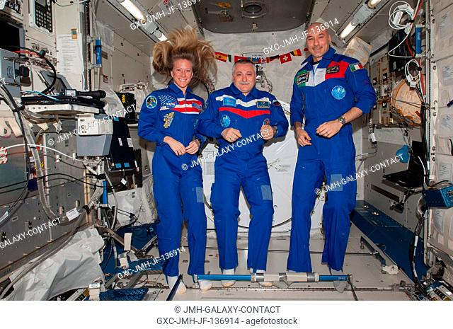 Russian cosmonaut Fyodor Yurchikhin (center), Expedition 37 commander; along with NASA astronaut Karen Nyberg and European Space Agency astronaut Luca Parmitano