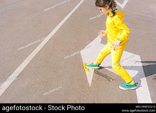 Girl stepping on banana peel on a street