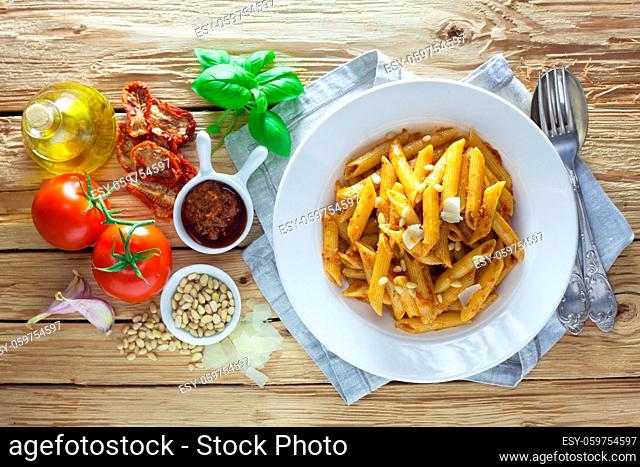 Pasta With Pesto Rosso On A Wooden Background