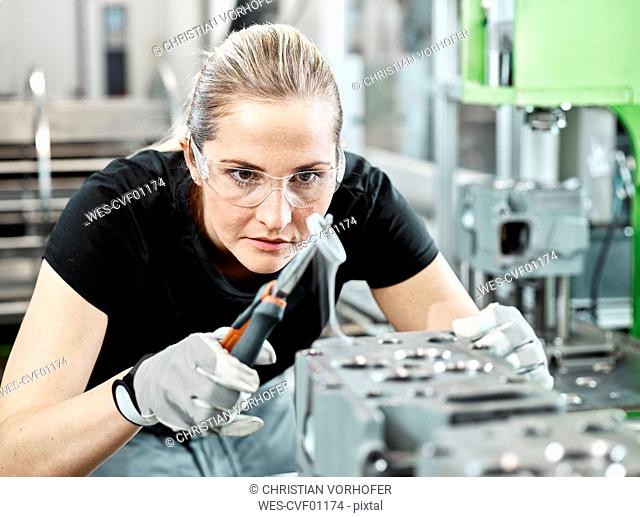Young woman working with a pliers