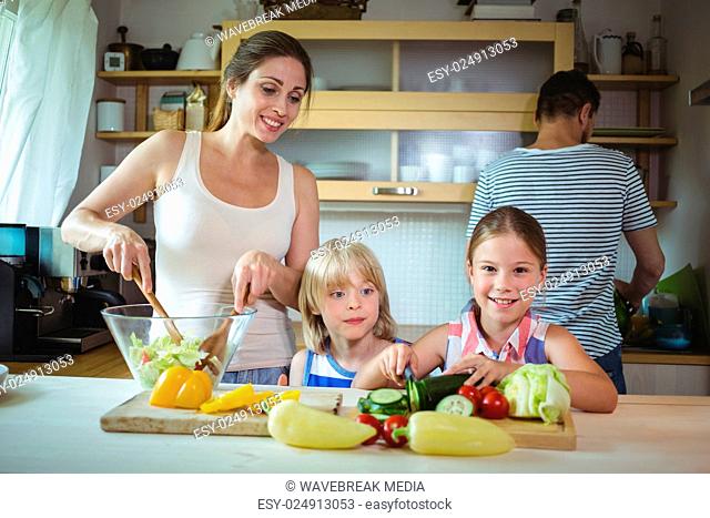Mother and daughter preparing salad in the kitchen
