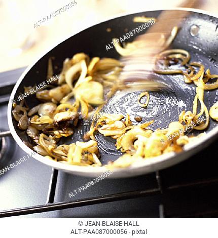 Close-up of onions being sauted in a pan