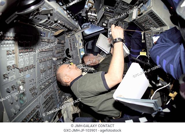 Astronauts Dominic L. Gorie (background), STS-108 commander, and Mark E. Kelly, pilot, are in their respective stations during rendezvous operations with the...
