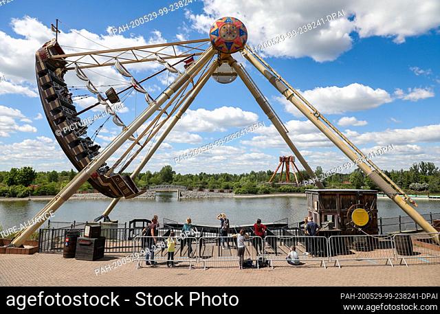29 May 2020, Saxony, Leipzig: Visitors take a ride on a giant swing boat in the Belantis amusement park. Saxony's Minister of Tourism praised the leisure and...