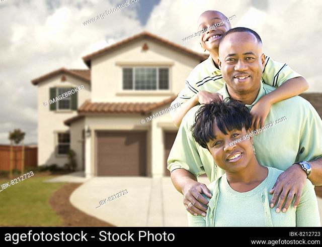 Attractive african american family in front of beautiful house