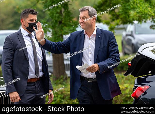 15 September 2021, Bavaria, Garching: Markus Söder (CSU), Minister-President of Bavaria, waves in the direction of a group of disruptors before the Chancellor's...