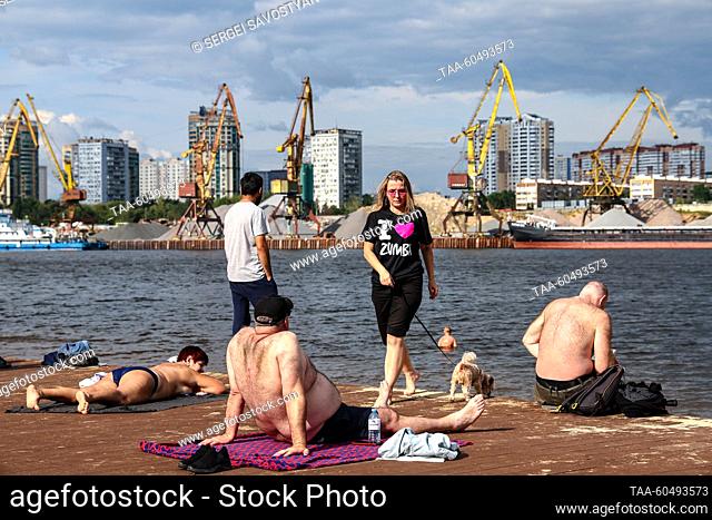 RUSSIA, MOSCOW - JULY 16, 2023: People are seen by the Moscow Canal in Severnoye Tushino Park. Sergei Savostyanov/TASS