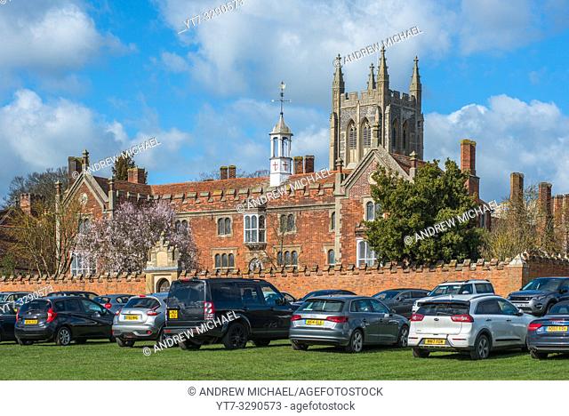 Hospital of the Holy and Blessed Trinity with Holy Trinity Church to the rear, in the village of Long Melford, Suffolk, East Anglia, UK