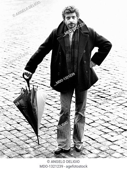 Portrait of Giancarlo Giannini with an umbrella in his hands. Portrait of the Italian actor and voice actor Giancarlo Giannini with an umbrella in his hands