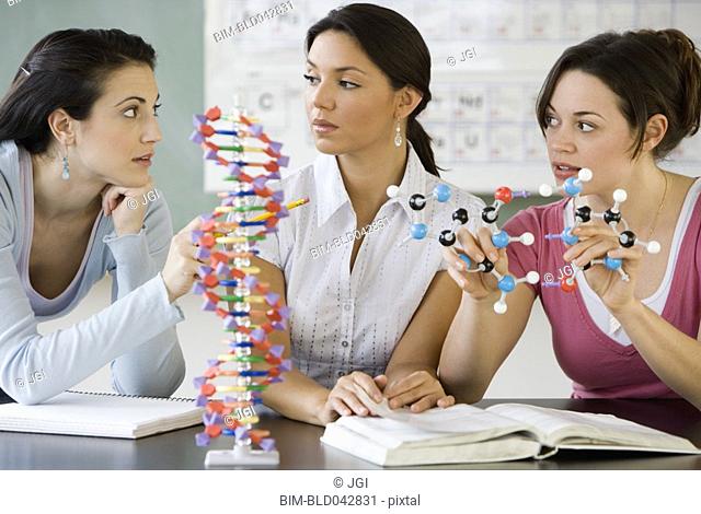 Three young women in science class