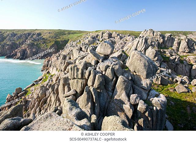 Granite sea cliffs at logan rock Headland in Porthcurno, Cornwall, UK