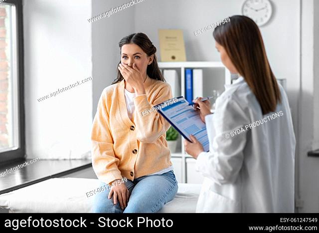female doctor and coughing woman at hospital