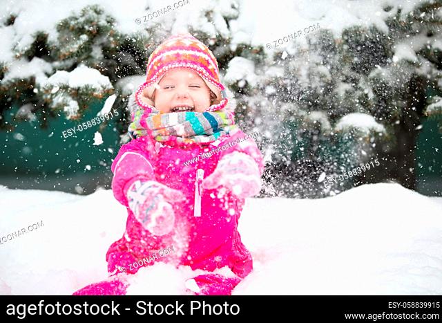 Belarus, the city of Gomel on March 2, 2018. Kindergarten for children.A girl in winter near a fluffy pine tree in bright clothes