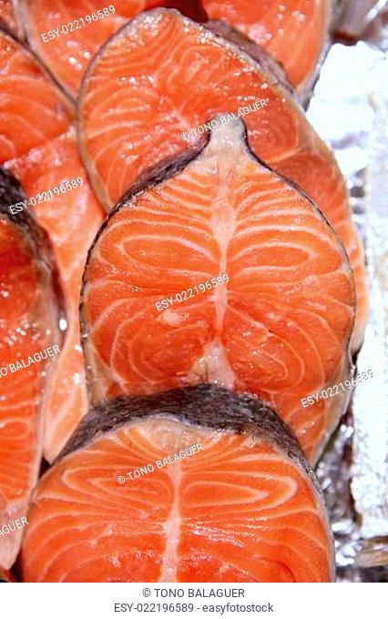 Salmon fish vivid slices in a row
