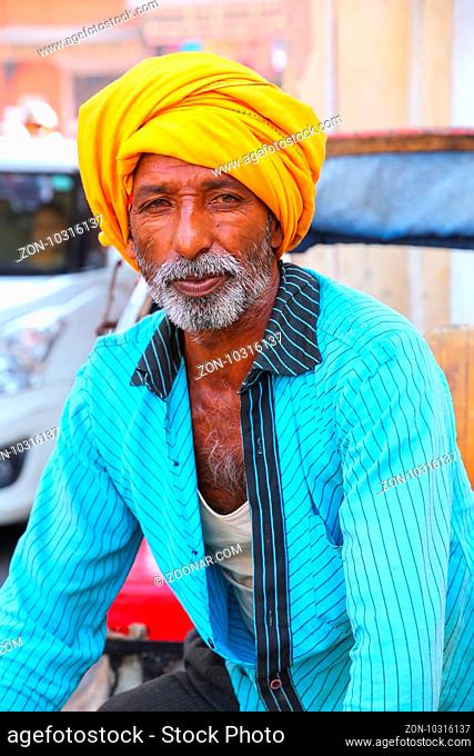 Portrait of cycle rickshaw driving in the streets of Jaipur, Rajasthan, India. Jaipur is the capital and the largest city of Rajasthan