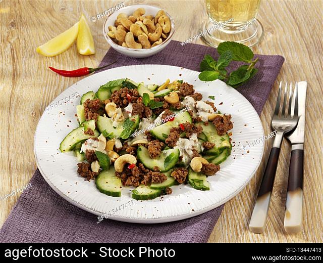 Spicy cucumber salad with minced meat and a cashew nut dressing