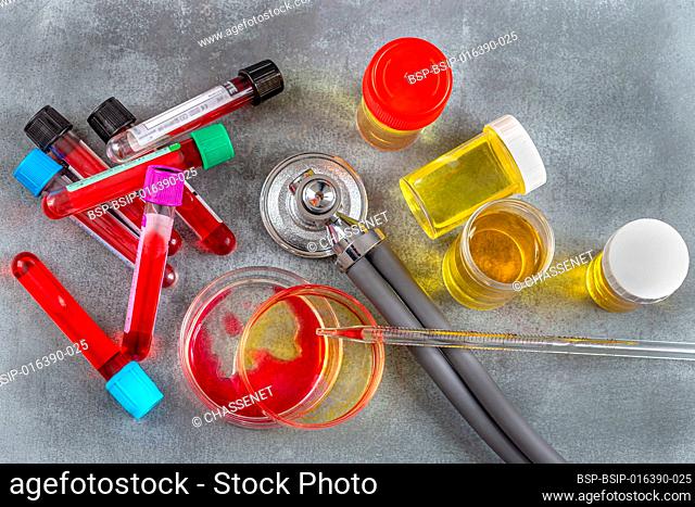 Blood tubes, urine bottles, Petri dishes and stethoscope seen from above