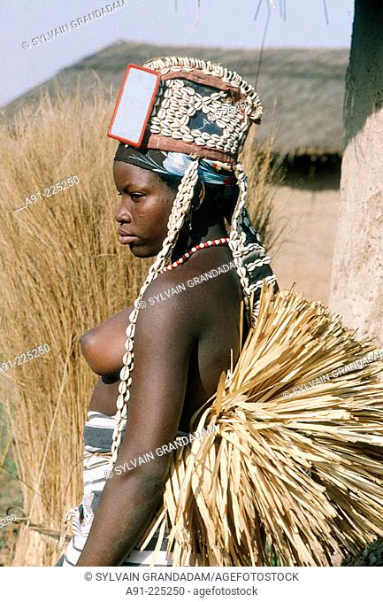 Young girl wearing the traditional dress for initiation dances in a village near Boundiali. Senufo Country. North Ivory Coast