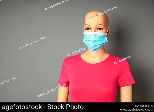 a store window mannequin or display dummy wearing medical face mask